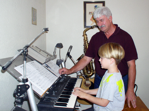 photo of george teaching a student the keyboard